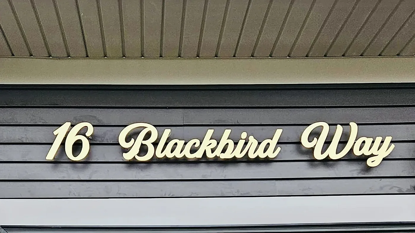 16 Blackbird Way in gold letters raised on stainless standoffs