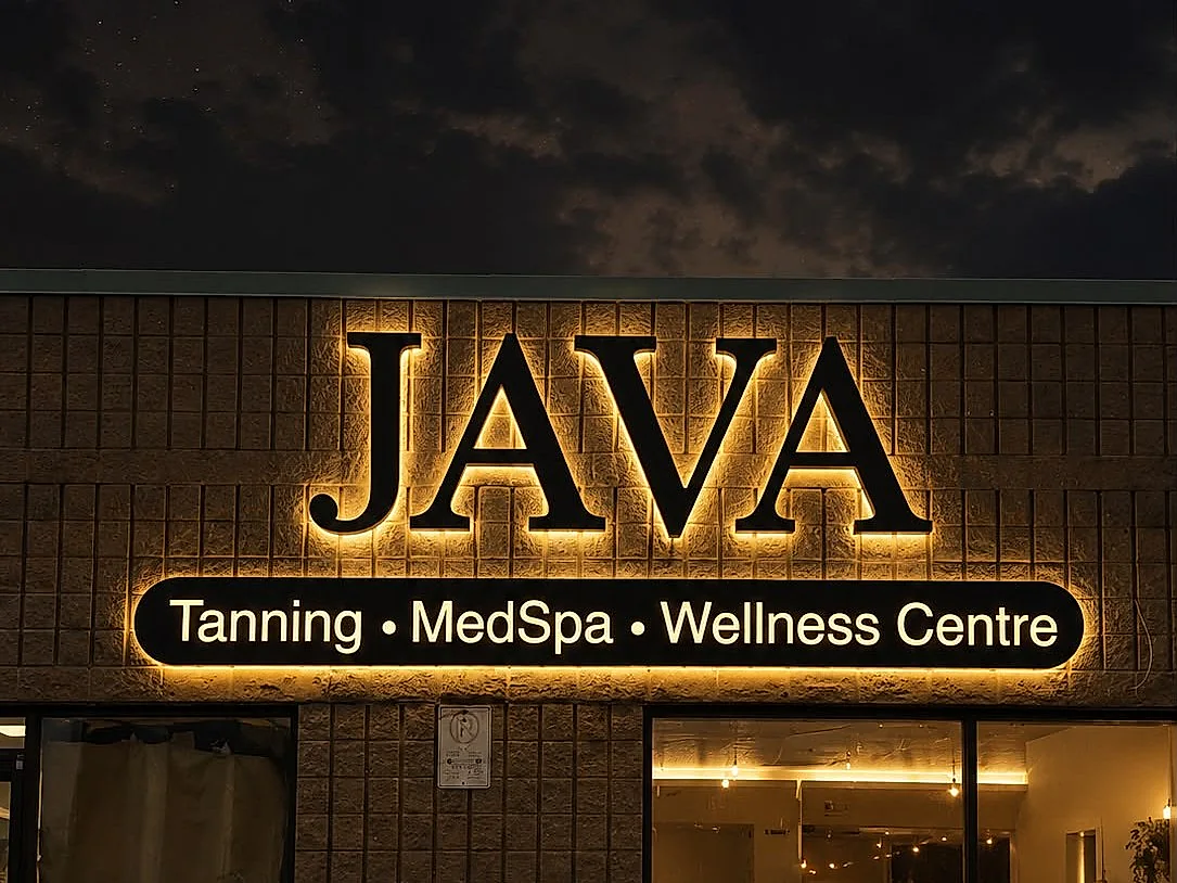 Storefront lettering being installed on a brick fascia